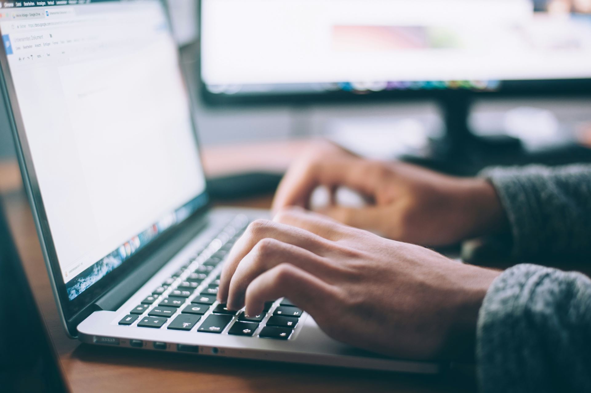 hands at a laptop